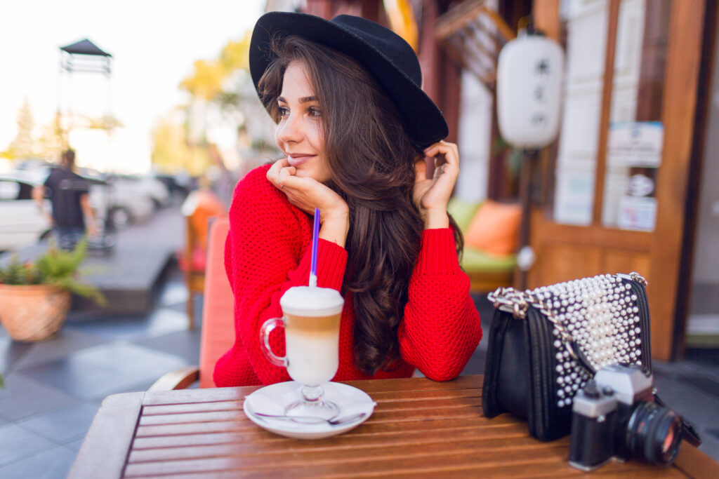 stunning young lady stylish black hat bright red sweater sitting open space cafe drink coffee with milk cappuccino